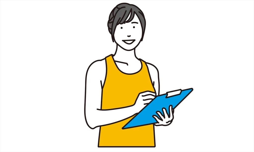 23072443 1 | 外苑前のパーソナルジム|QUALITAS青山外苑前店 バインダー持って説明してる女性トレーナー